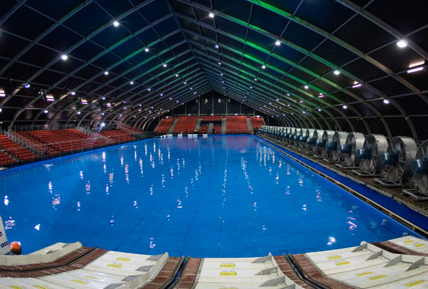 Indoor windsurfing pool with fans making wind